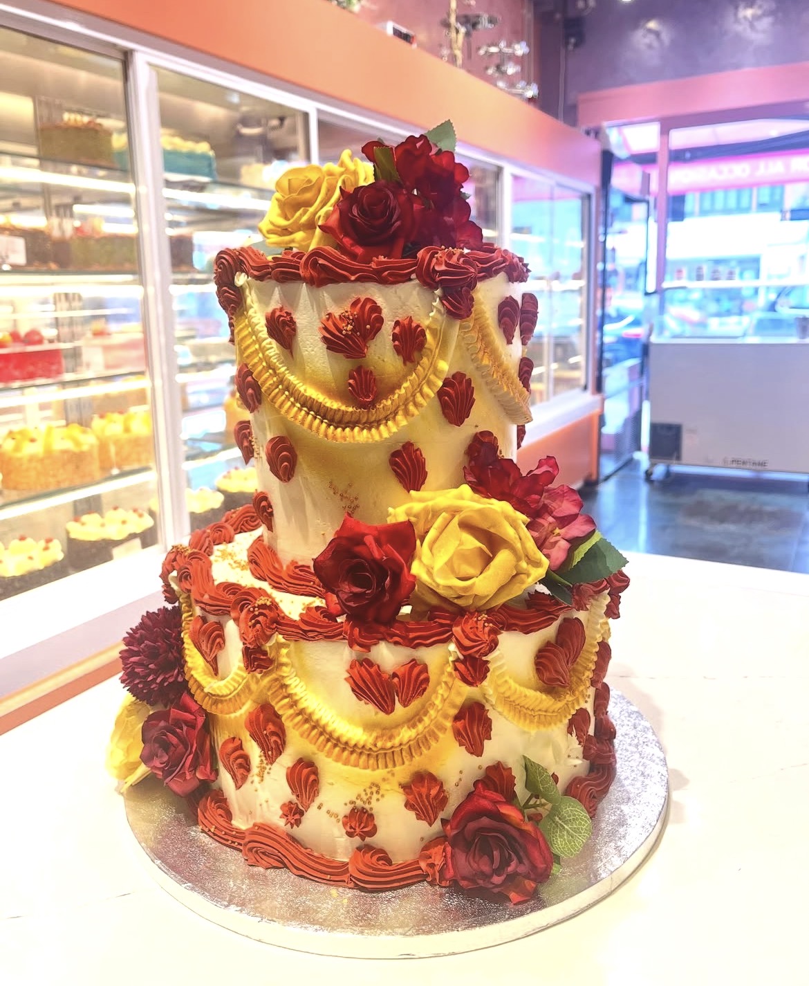 Two tier red and gold celebration cake